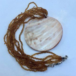 Polished Natural Shell Medallion Pendant on Strung Seed Beads